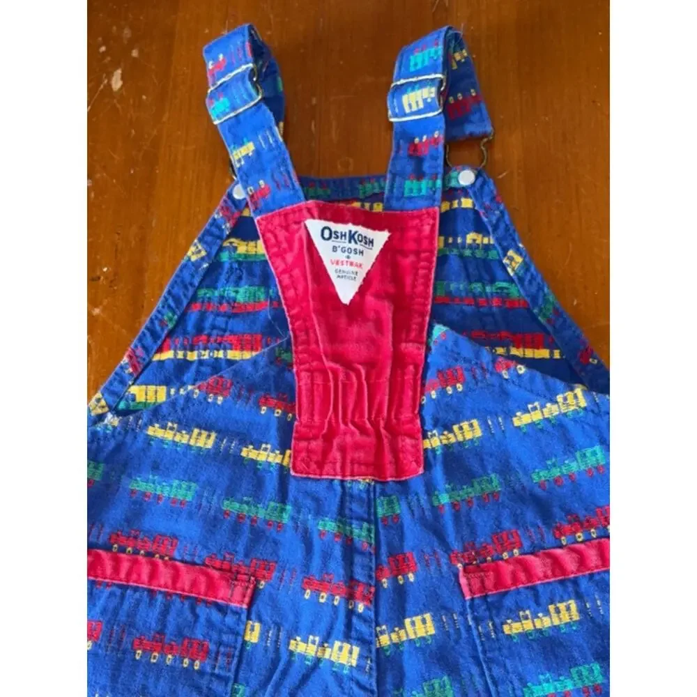 OshKosh B'gosh Bright Blue Overalls with Red, Yellow and Green Train Print